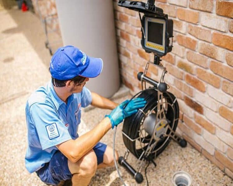 Man Working On Blocked Drain