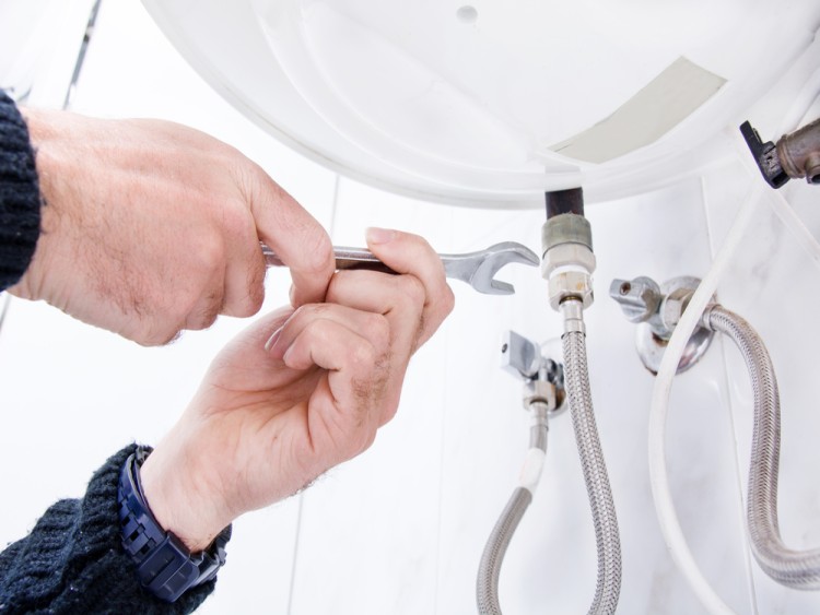 Plumber Fixing Hot Water Service