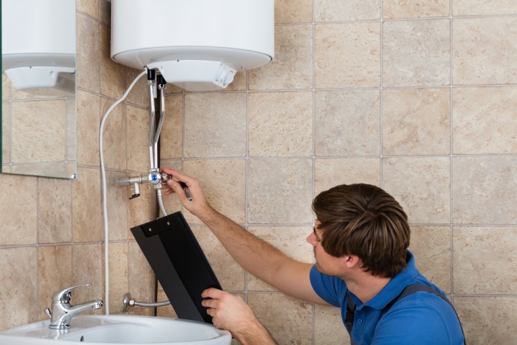 Male Plumber Checking Hot Water Boiler