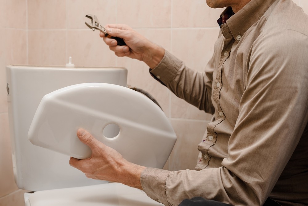 Plumber Repairing Toilet