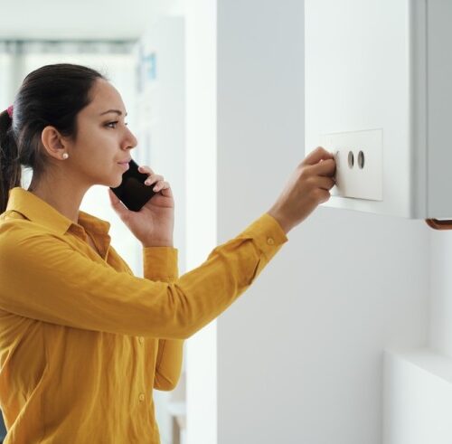 Woman Calling A Plumber For Hot Water Issue