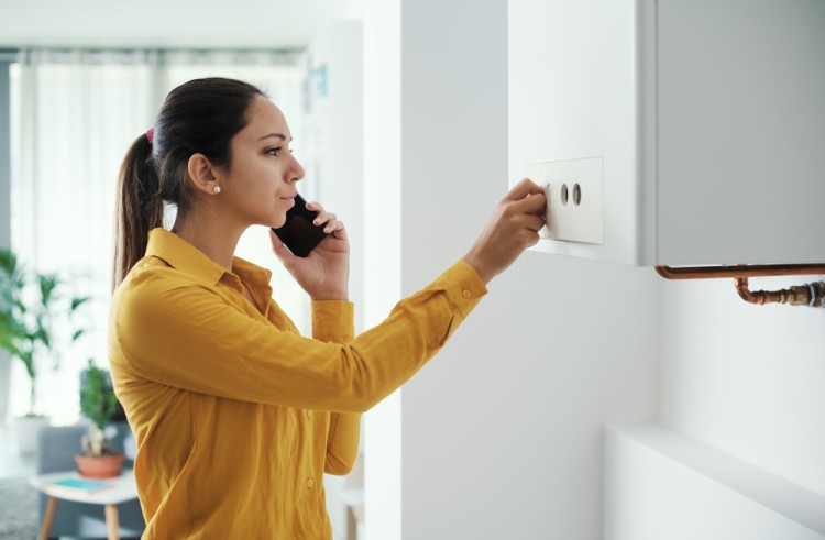 Woman Calling A Plumber For Hot Water Issue